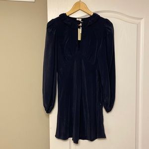 Dark blue peephole dress with long sleeves.